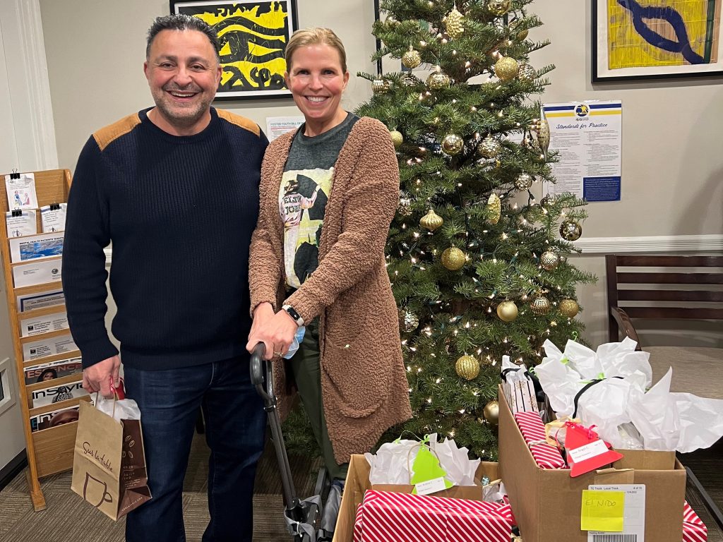 Payman and Jan Emamian deliver presents for Sycamores foster youth.