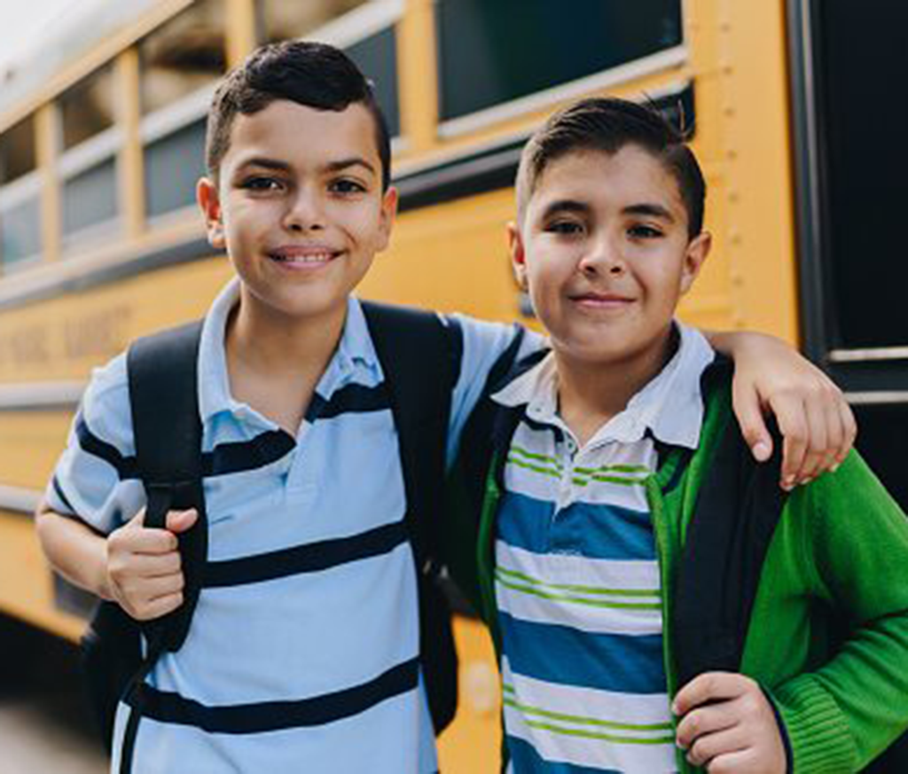 Two buys standing by SchoolBus